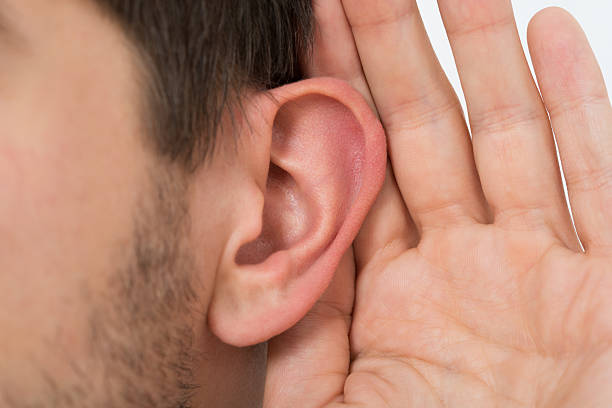istock Person Trying To Hear With Hand Over Ear 586046454