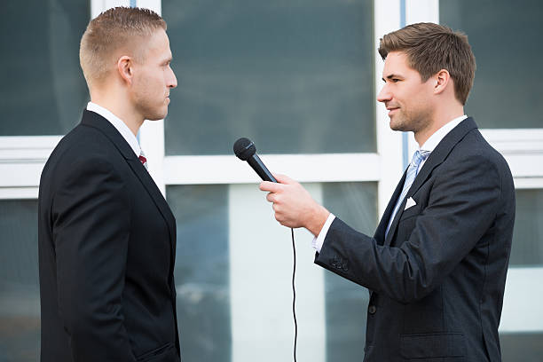 istock Journalist Interviewing Businessman Outdoors 586046746