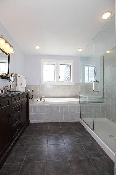 istock Bathroom with tub and wood cabinet with two sinks 586048106