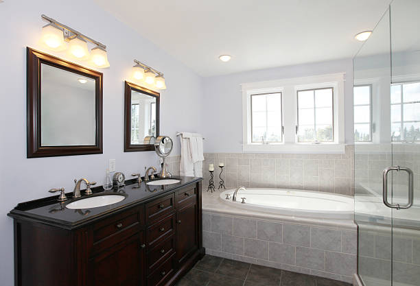 istock Bathroom with tub and wood cabinet with two sinks 586048160