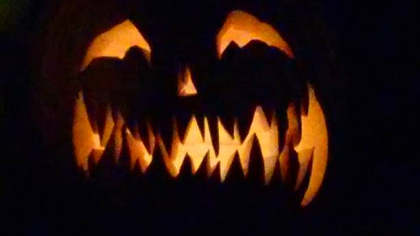 istock Glowing Halloween Jack-0-Lantern Pumpkin 586048398