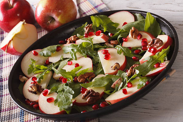 istock Apple salad with pomegranate, nuts and arugula close-up. horizontal 586049136