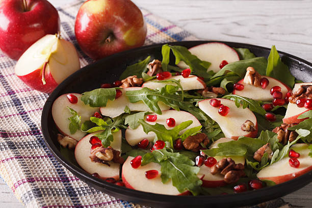 istock Fresh salad with apples, pomegranates, walnuts and arugula 586049332