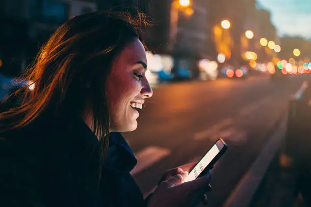 Photo of Woman texting at night