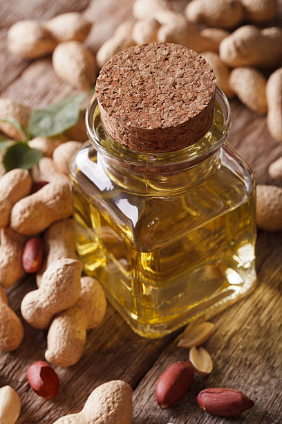 istock Natural peanut oil in a glass jar macro. vertical 586049980