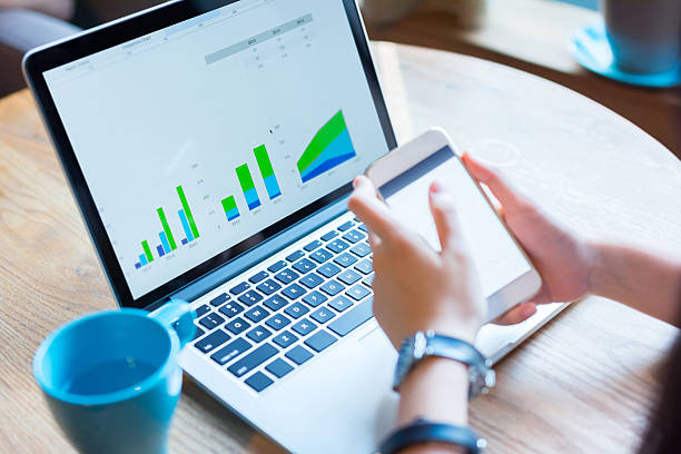 istock Businesswoman using smartphone and laptop. 586050664