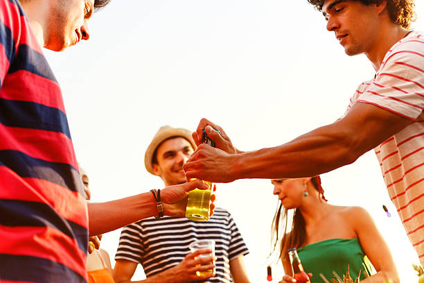 istock Opening a bottle of beer during party 586052144