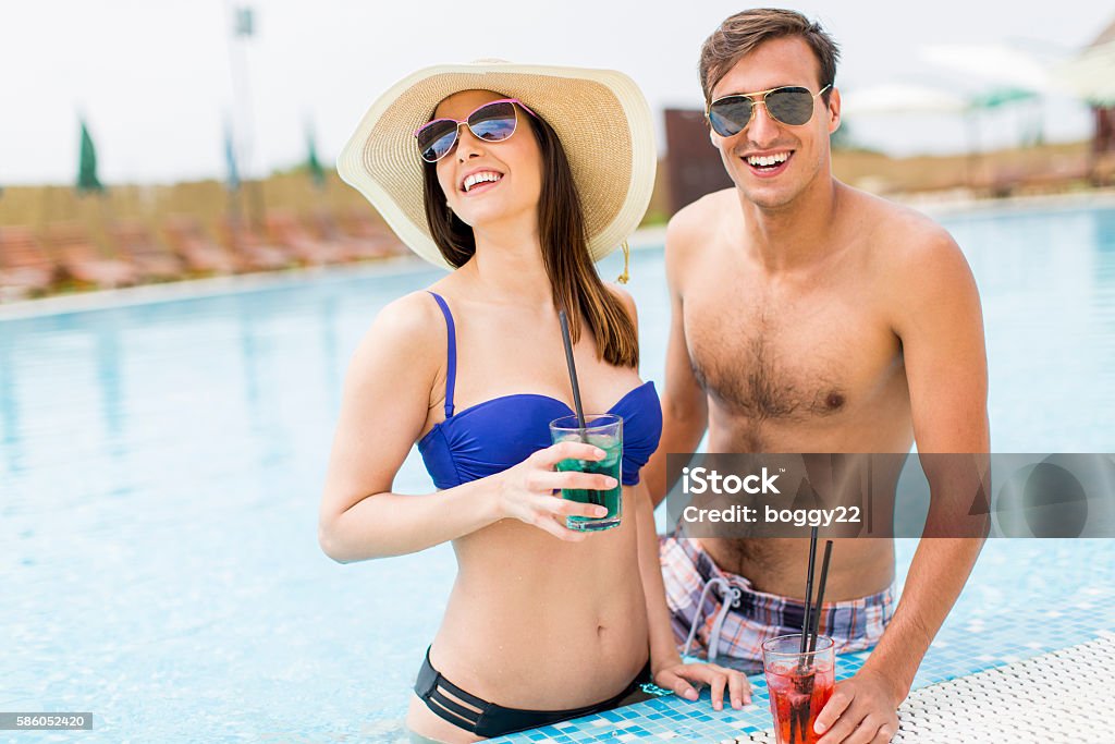 Young couple by the pool Adult Stock Photo