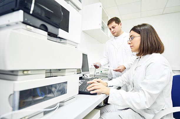 Researchers analyzing liquid chromatography data Pharmaceutical scientific researchers analyzing liquid chromatography data at pharmacy industry manufacture factory laboratory chromatography stock pictures, royalty-free photos & images