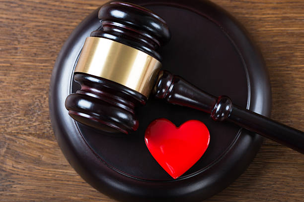 istock Mallet And Heart On Table In Courtroom 586053444