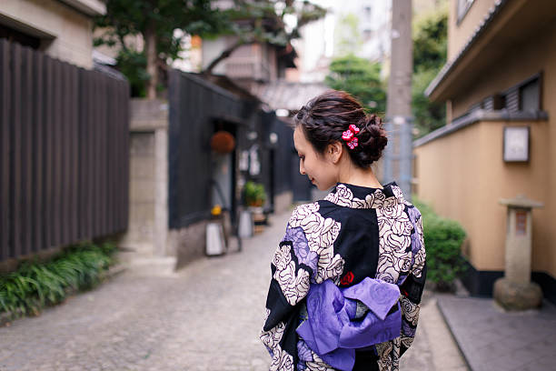 istock Young Yukata woman walking on stone-paved path 586054286