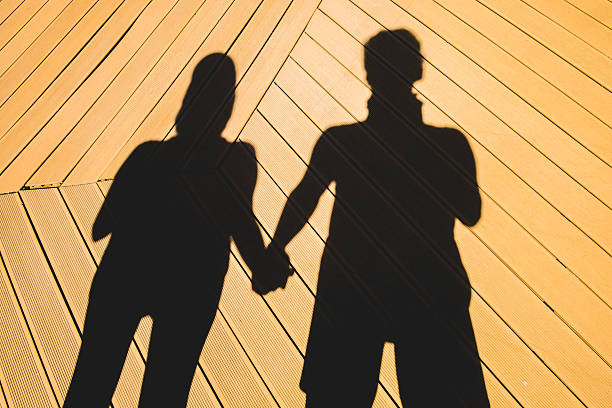 istock Couple holding hand in a shadow 586054468