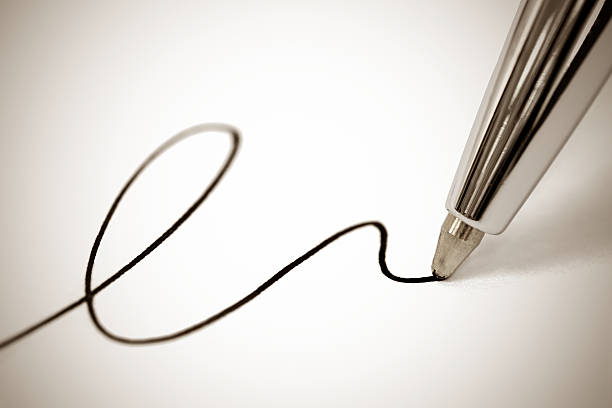 Ballpoint pen writing Macro picture of a ballpoint pen writing a signature on paper, sepia toned ballpoint pen photos stock pictures, royalty-free photos & images