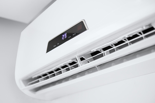 Split air conditioner on a white wall. Closeup image.