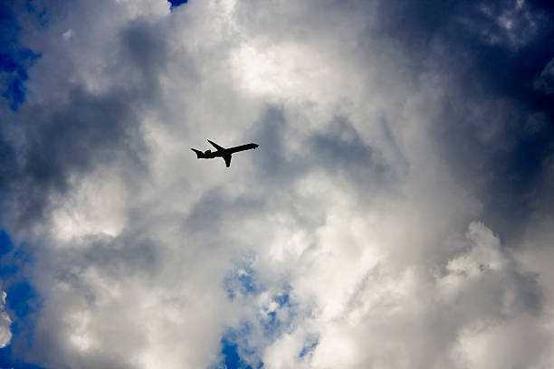 istock Airplane flying in the sky 586057376