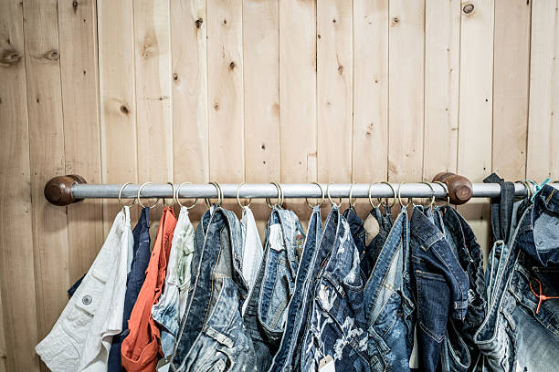 Jeans and demin clothes hanging at a clothing store - fashion industry concepts
