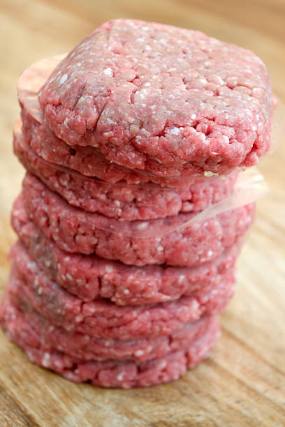 istock pile of raw hamburgers 586059454