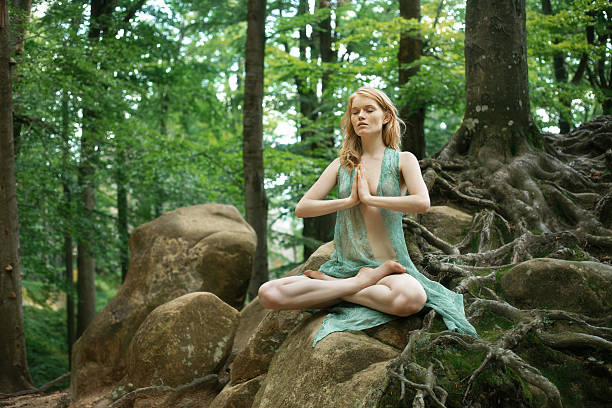 istock woman meditating and doing yoga 586060234