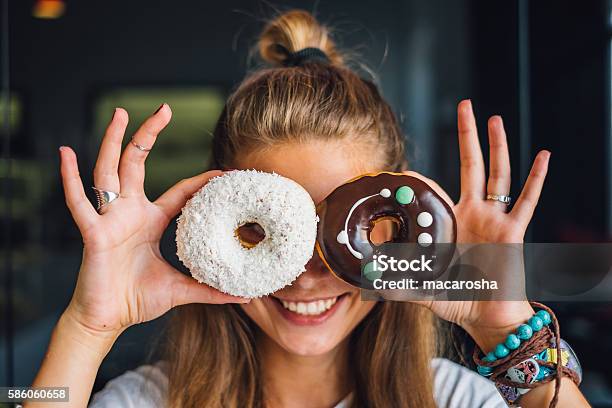 Happy Woman Holding Donuts Stock Photo - Download Image Now - Doughnut, Eating, Dessert - Sweet Food