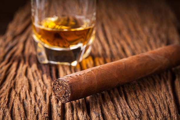 istock cigar and whisky on old wooden table 586062332