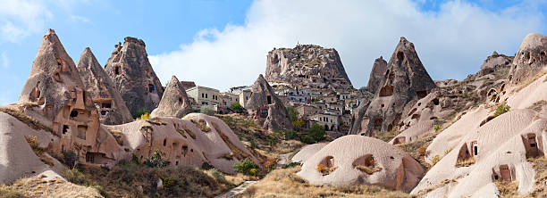 Uchisar castle and unique geological formations in Cappadocia, T Panorama of Uchisar castle and unique geological formations in Cappadocia, Turkey. Cappadocian Region with its valley, canyon, hills located between the volcanic mountains Erciyes, Melendiz and Hasan. rock hoodoo stock pictures, royalty-free photos & images