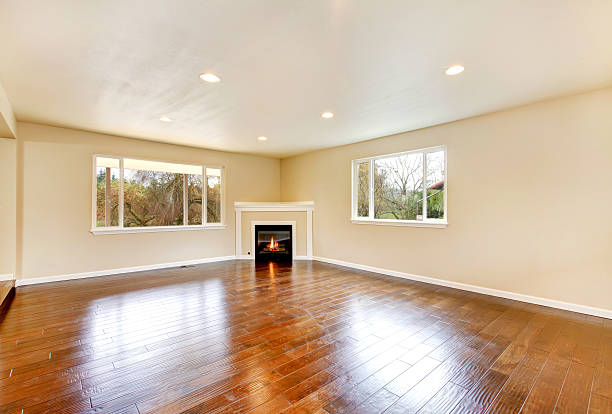 istock Empty living room with polished hardwood floor and corner fireplace. 586062970