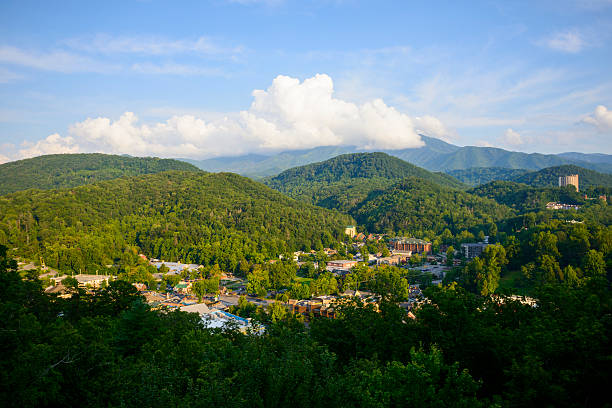 Town of Gatlinburg, Tennessee in summer High angle view in summer of downtown Gatlinburg, Tennessee, a popular vacation destination located at the entrance to Great Smoky Mountains National Park. gatlinburg stock pictures, royalty-free photos & images