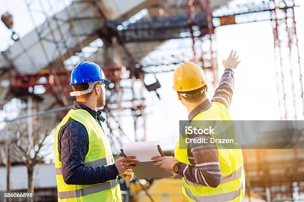 Reporting To Contractor At Construction Site Stock Photo - Download Image Now - Construction Industry, Construction Site, Bridge - Built Structure