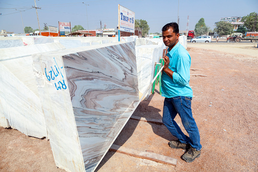 Kishangar, India - October 20, 2012: marble plates for sale in the marble shop in Kishangar, India. The town depends  on the marble and has more than  25000 marble traders.
