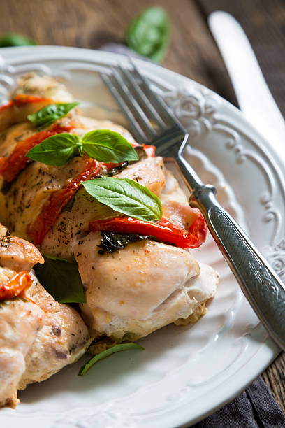 istock Baked chicken breast with mozzarella and cherry tomatoes with basil 586069132