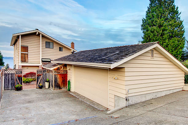 istock View of separate garage with concrete driveway. 586069222