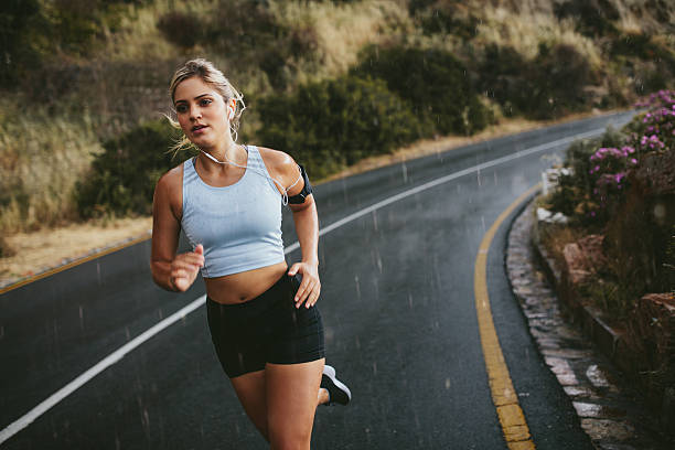 istock Fit young woman running on highway 586069408