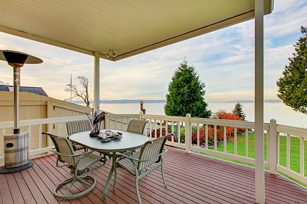 istock Awesome water view from the wooden deck with patio table 586069578