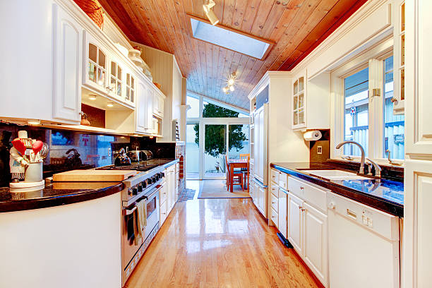 istock White kitchen cabinets with black counter tops in luxury house. 586069858