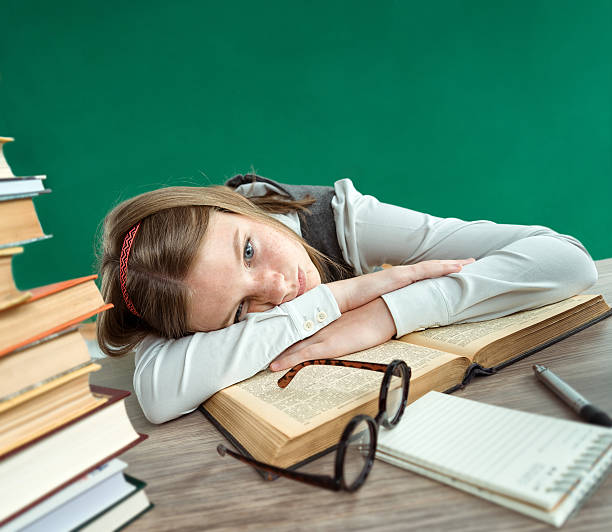 istock Tired student lies on the books. 586070146