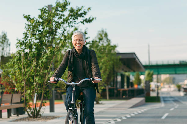 istock Mature Woman Riding  Her Bicycle. 586070360