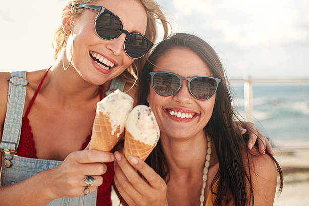 istock Two young friends having ice cream outside 586070426