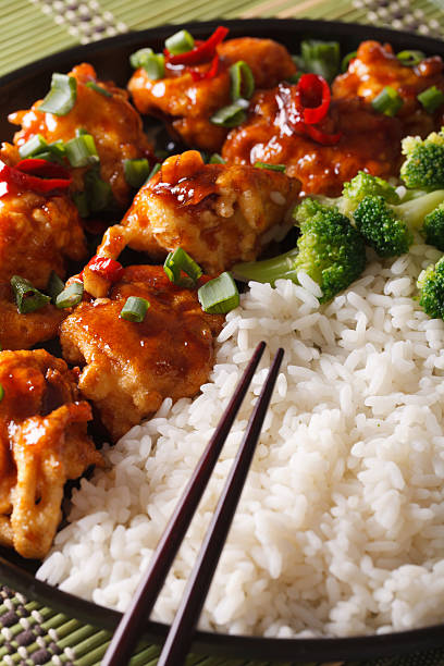istock Asian Chicken tso with rice and broccoli close-up. vertical 586070780