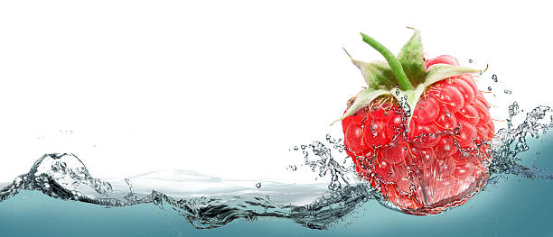 istock Raspberries in a spray of water. 586071172