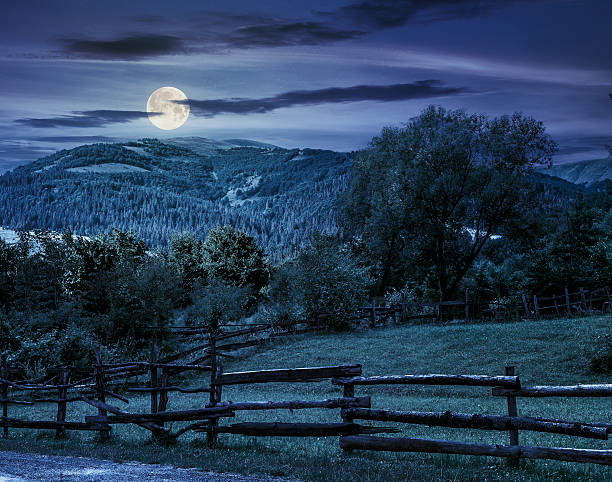 istock wooden fence on hillside at night 586071366