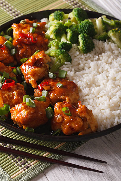 istock General Tso's chicken with rice, onions and broccoli closeup 586071882