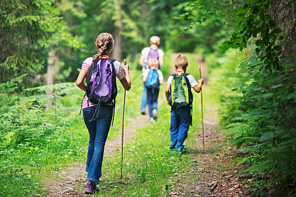istock Mother and kids hiking in forest 586072016