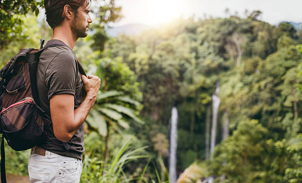 istock Man hiking near waterfall 586072046