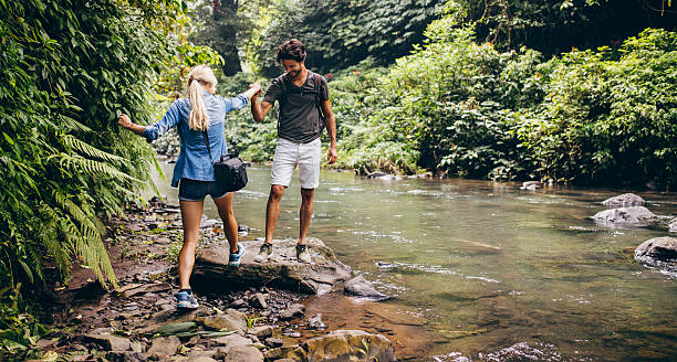istock Young couple hiking in the forest 586072324