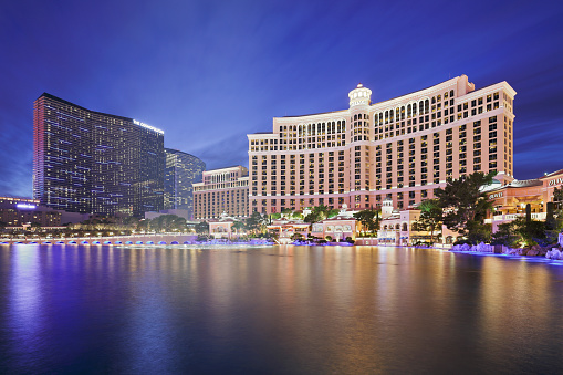 Las Vegas, USA - December 19, 2015: Skyscraper towers of Bellagio and the Cosmopolitan hotels reflected in the man made lake Bellagio. The luxury resort hotels are located on the Las Vegas strip.