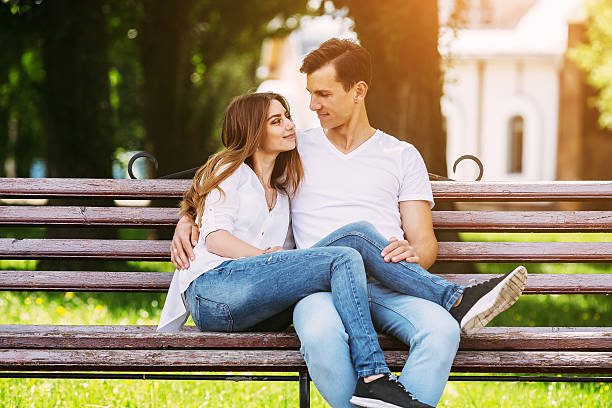 istock man and woman on a bench in the park 586076432