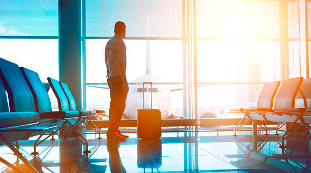 istock Passenger stands in airport terminal ready to board airplane 586076724