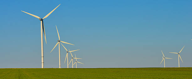 istock Windmills for electric power production on blue sky 586076798