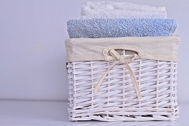 istock Soft Bath towels of different colors in wicker basket 586079548