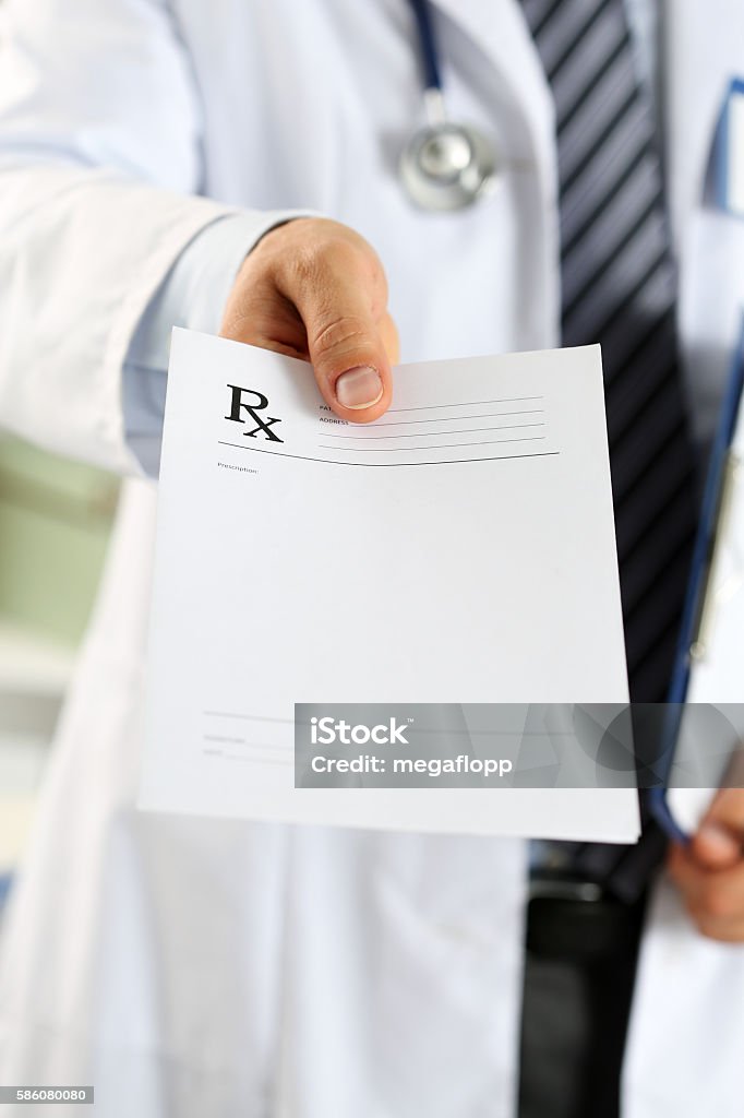 Male medicine doctor hand hold clipboard pad and give prescripti Male medicine doctor hand hold clipboard pad and give prescription to patient closeup. Panacea and life save, prescribe treatment, legal drug store, contraception concept. Empty form ready to be used Prescription Medicine Stock Photo